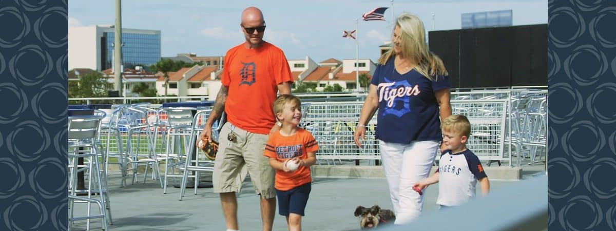 A family of four walking with their dog