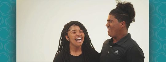 A girl and a boy smiling