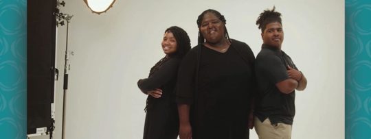 a mother posing for a picture with her two children