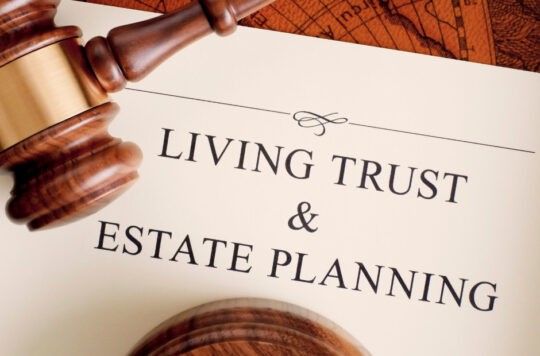 Gavel resting on estate planning document, legal and financial services for living trust and estate planning.