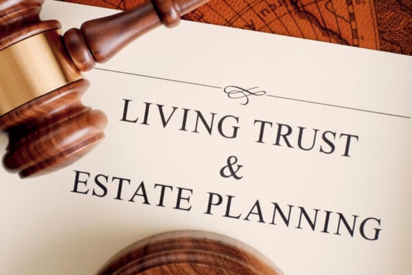 Gavel resting on estate planning document, legal and financial services for living trust and estate planning.