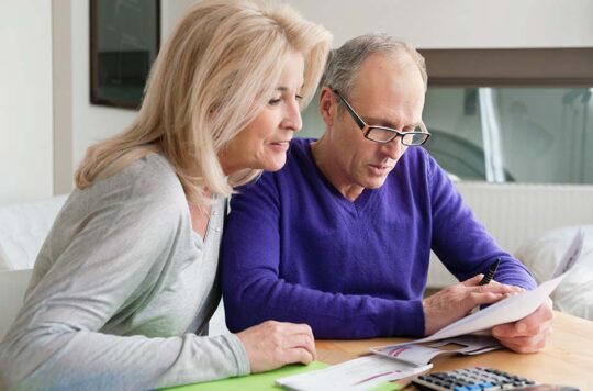 two adults reviewing paperwork