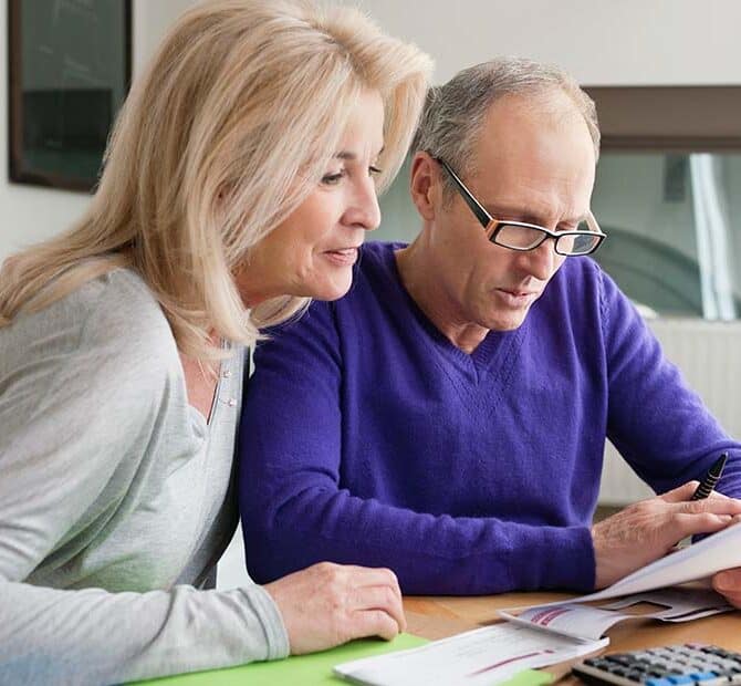 two adults reviewing paperwork