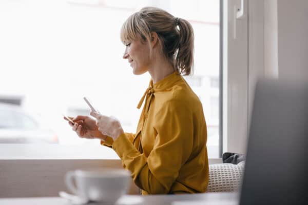 Woman looking at phone and credit card