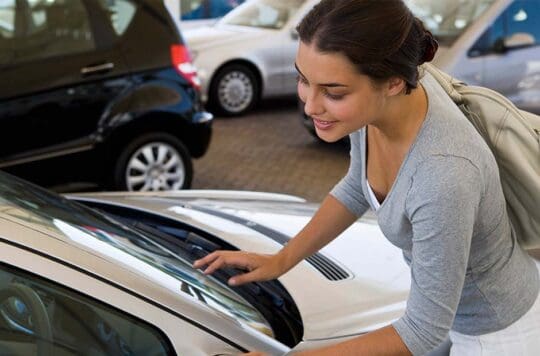 Woman looking at car inside a dealership
