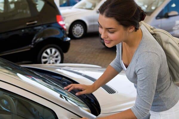 Woman looking at car inside a dealership