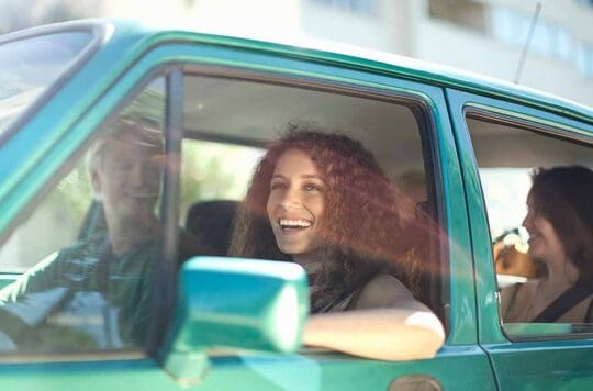 happy woman driving in car