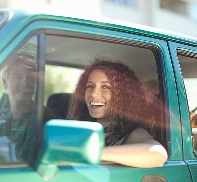 happy woman driving in car