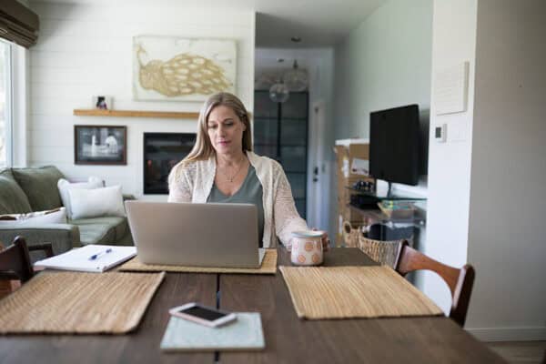 Woman home with laptop at table