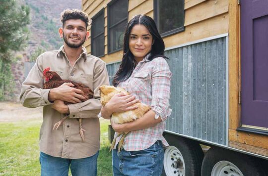 Couple with chickens and tiny home