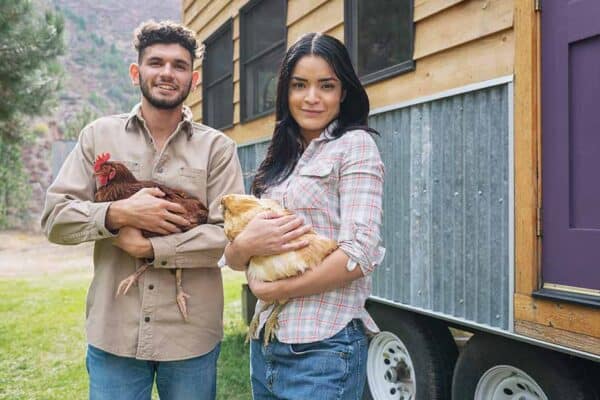 Couple with chickens and tiny home