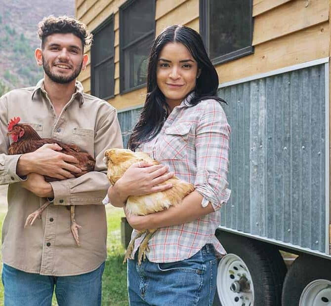 Couple with chickens and tiny home