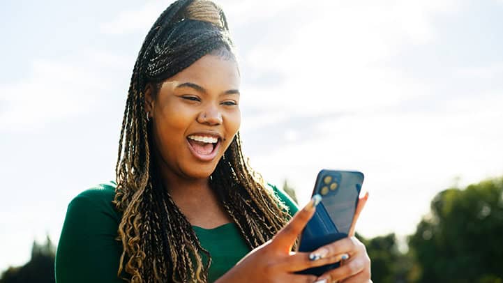Woman using smart phone with big smile