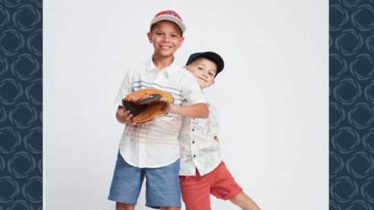 Two young boys pose together for a photo