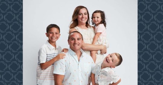 A family of five pose for a photo