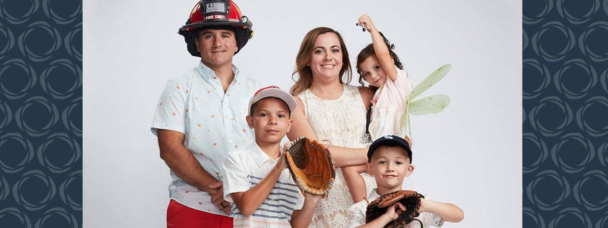 A family of five pose for a photo
