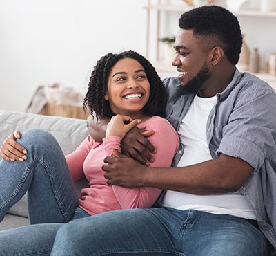 Romantic couple hugging on couch
