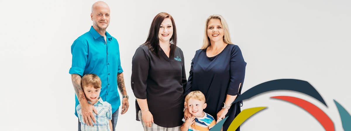 A family of four standing with their financial advisor. 